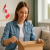 U.S. shopper receiving parcel from Canada with a smiling expression – concept of tariff-free shipping and Canadian parcel forwarder advantage.