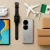 Huawei tablet, smartwatch, smartphone, and FreeBuds displayed alongside cardboard shipping boxes, a toy airplane, and the Mexican flag on a neutral background